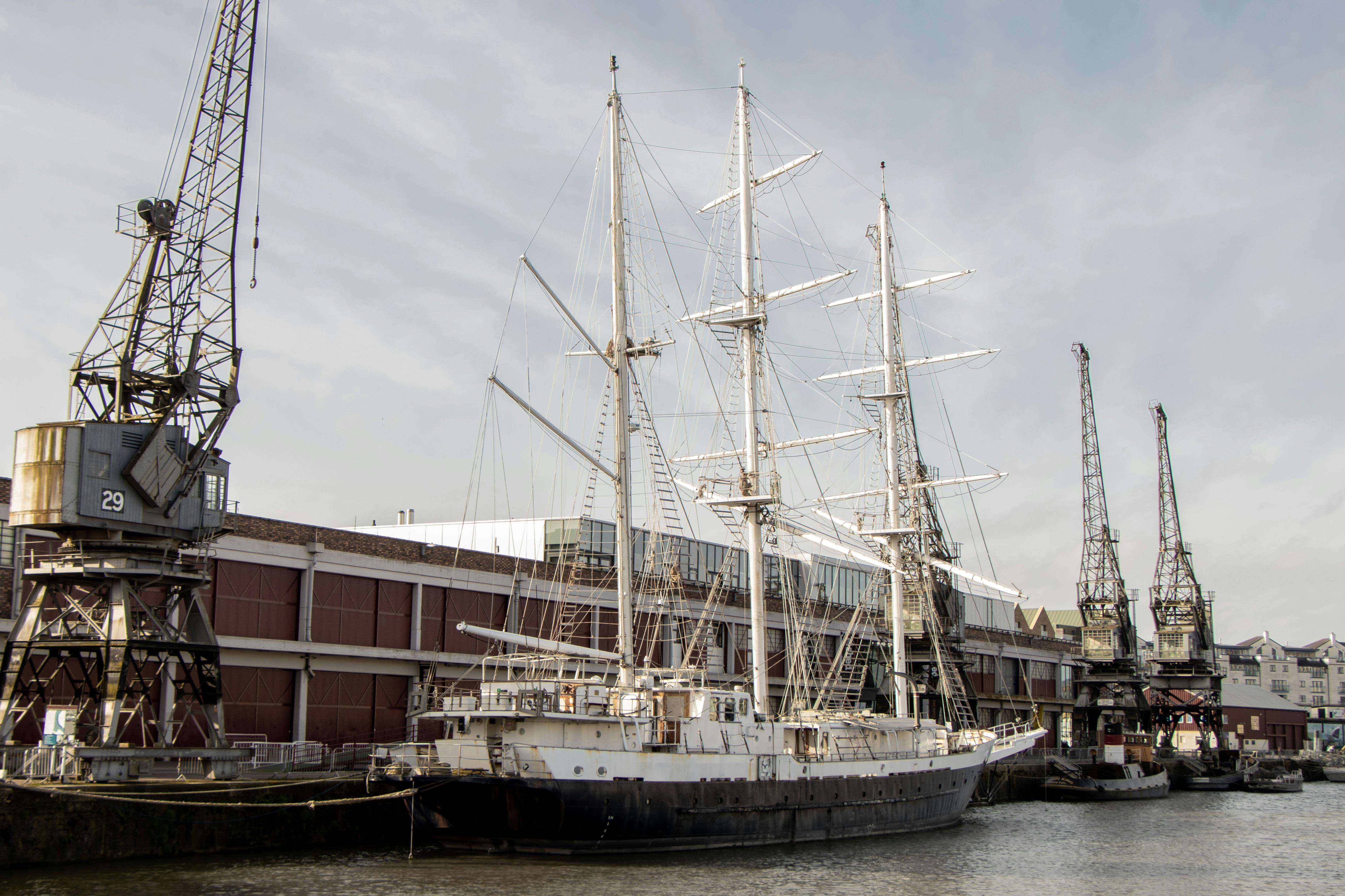 Grimsby docks with sailing ship and industrial cranes