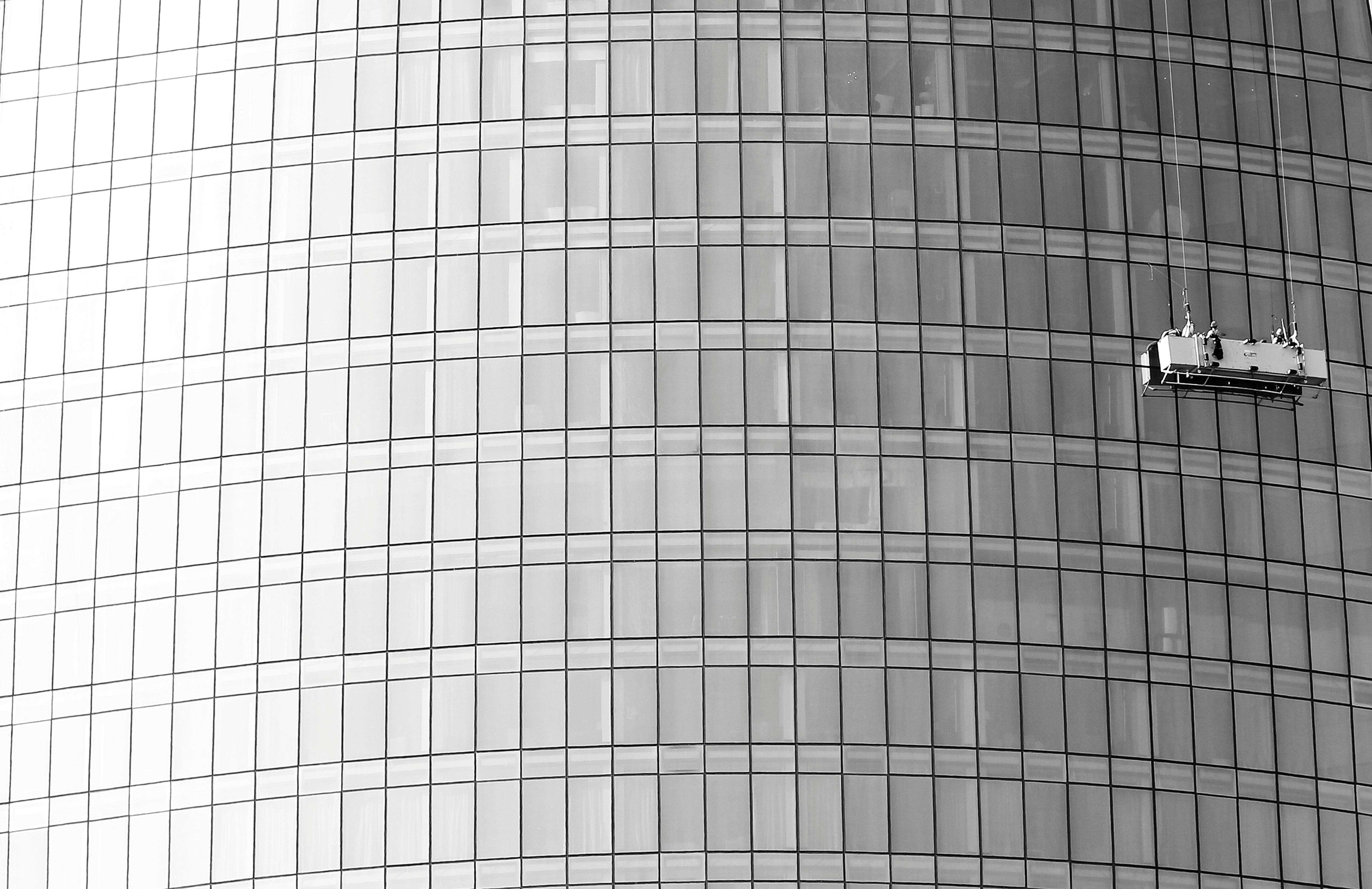 Modern glass skyscraper facade requiring glazing maintenance