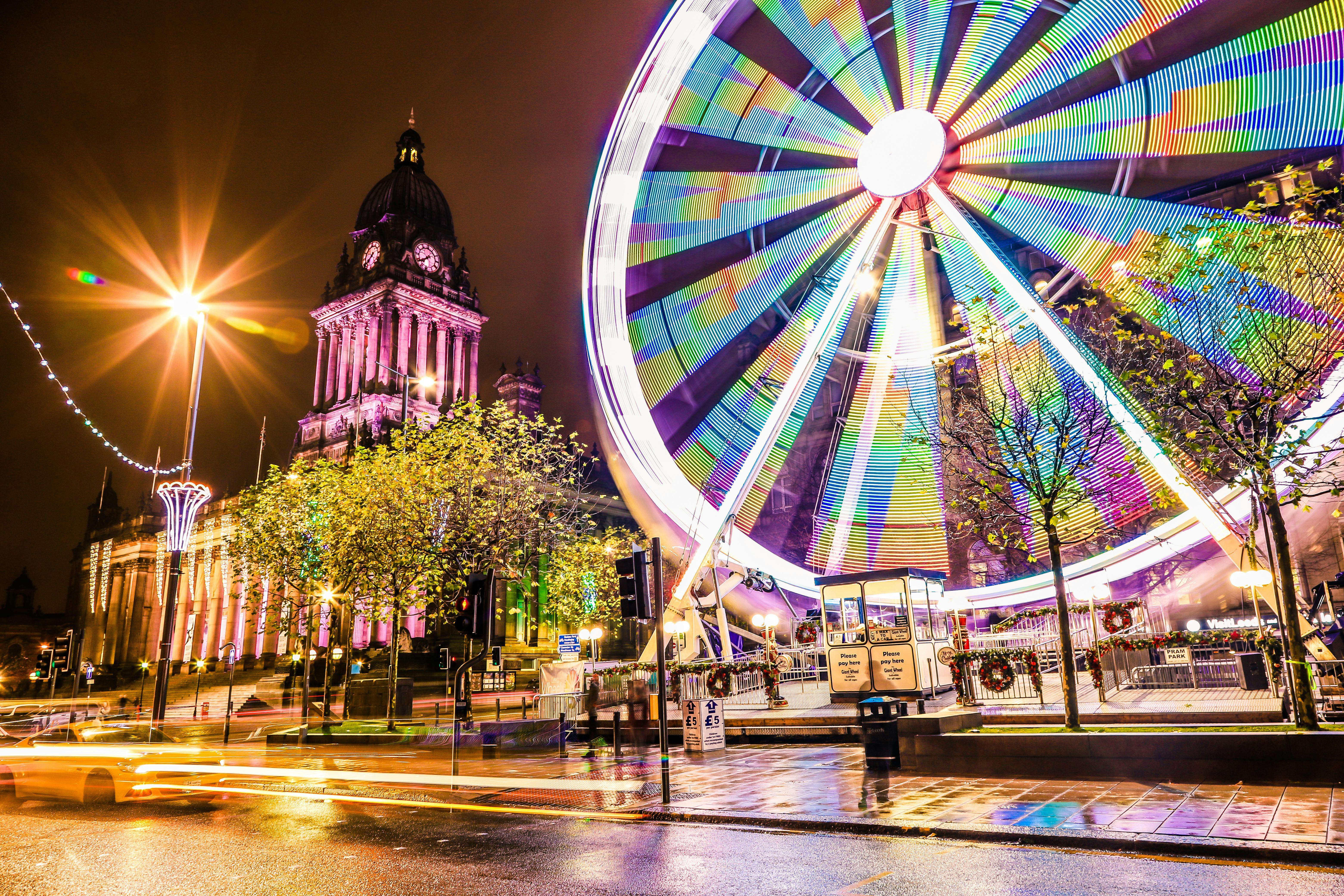 Leeds city centre at night with illuminated Ferris wheel