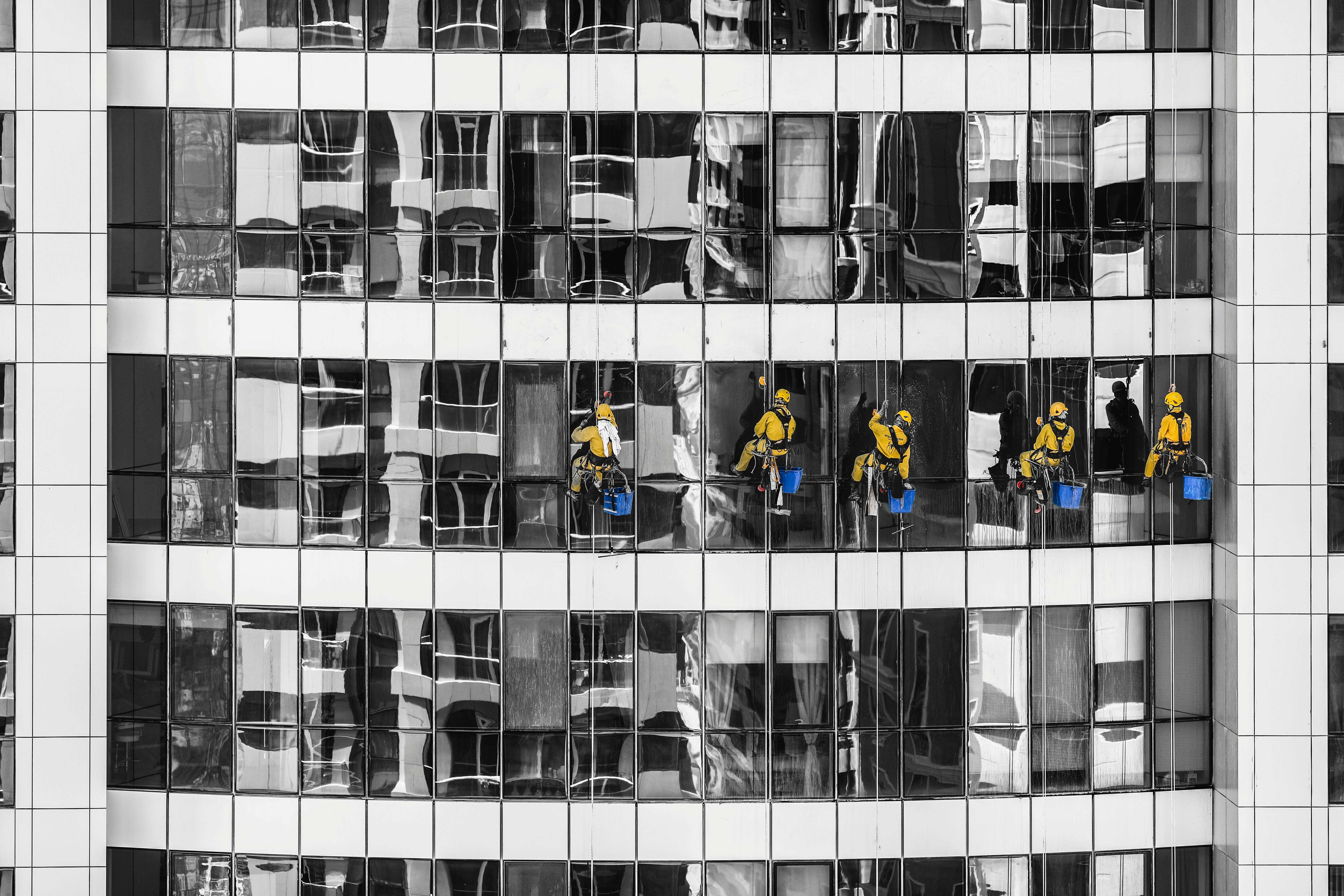 High-rise cleaners working on a glass skyscraper facade